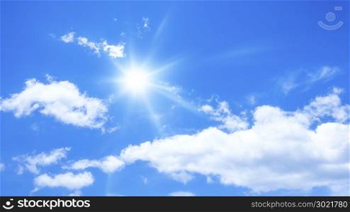 blue sky background with some clouds and the sun