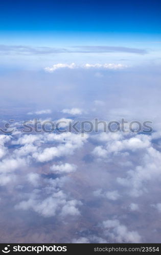 Blue sky background with tiny clouds