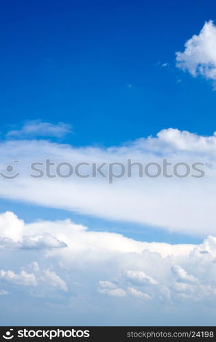 Blue sky background with tiny clouds