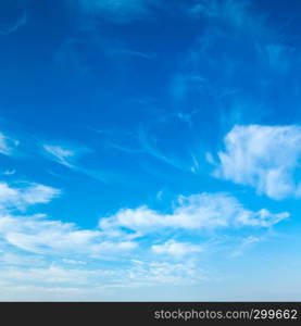 blue sky background with tiny clouds