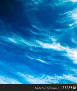 Blue sky background with tiny clouds