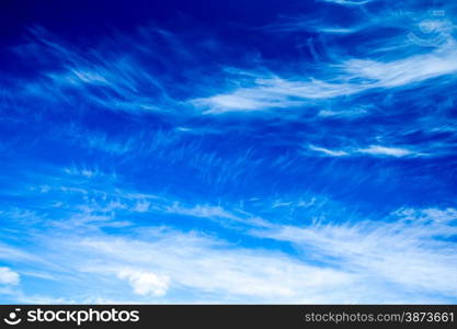 Blue sky background with tiny clouds