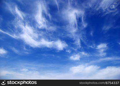 Blue sky background with tiny clouds