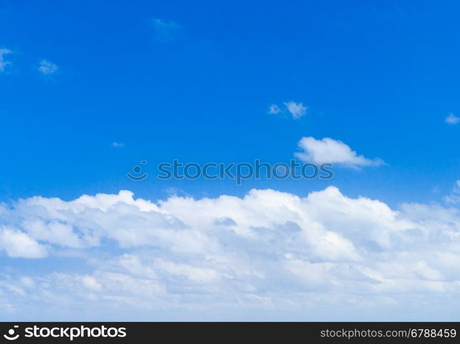 Blue sky background with tiny clouds