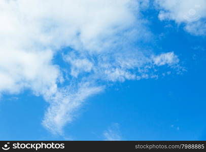 Blue sky background with tiny clouds