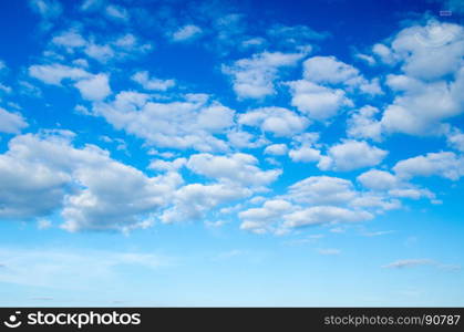 Blue sky background with tiny clouds