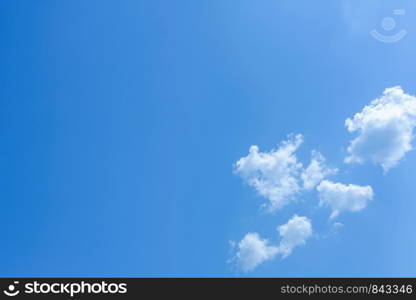 Blue sky background with tiny white clouds.