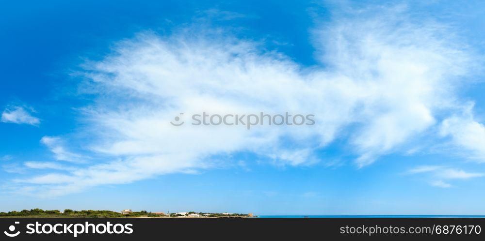 Blue sky background with white clouds and sea coast.