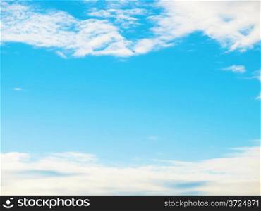 Blue sky framed between clouds background