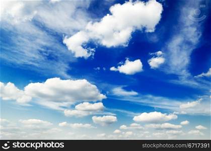 blue sky is covered by white fluffy clouds
