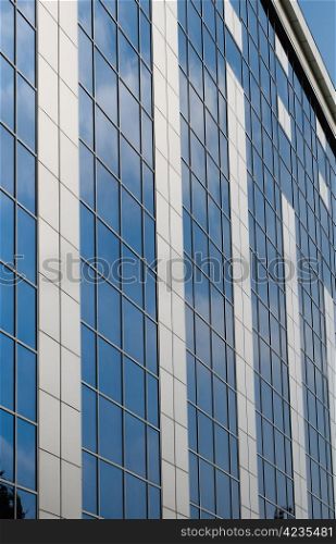 Blue sky reflected in the windows of office building