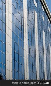 Blue sky reflected in the windows of office building
