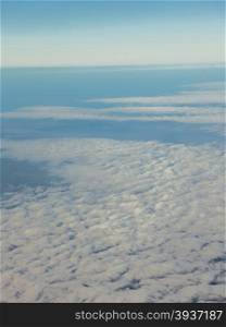 Blue sky. View from window of airplane flying in clouds. Skyscape cloudscape. Bird&#39;s eye.