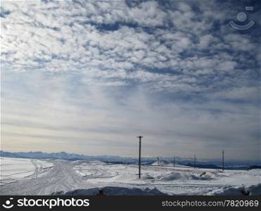Blue sky with a little clouds and winter caucasus mountain landscape