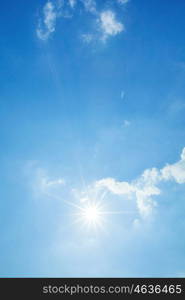 Blue sky with clouds and sun. Blue sky with white clouds and shiny sun