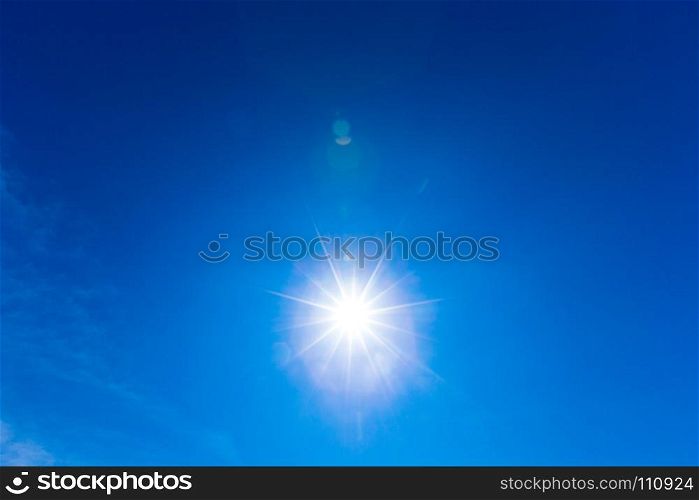 blue sky with clouds and sun reflection