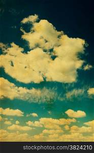 Blue sky with clouds in grunge and retro style.