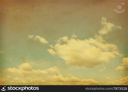 Blue sky with clouds in grunge and retro style.