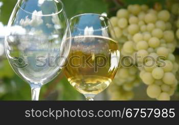 Blue sky with clouds reflected in the glass of wine