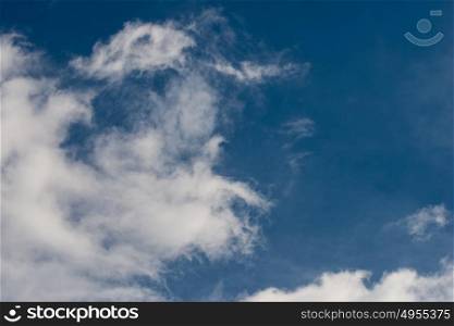 Blue sky with fluffy cotton clouds background