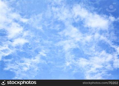 Blue sky with light fleecy clouds, may be used as background