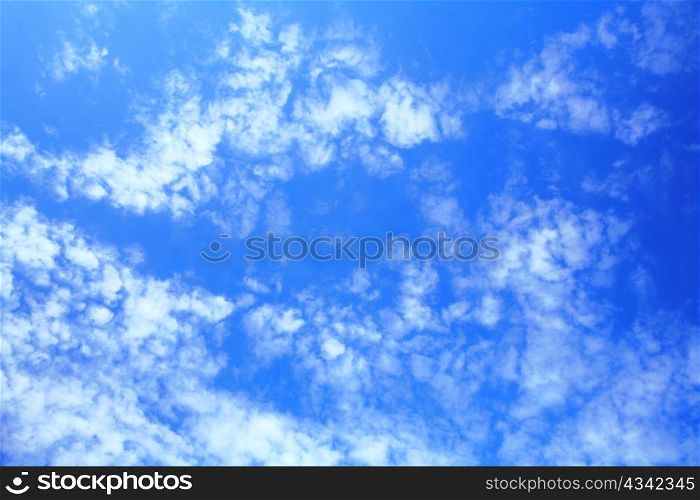 Blue sky with little clouds on it