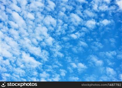 Blue sky with lots small white fleecy clouds - textured background