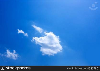Blue sky with one cumulus and sunlight