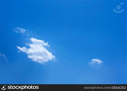 Blue sky with one cumulus and sunlight