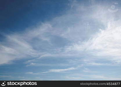 Blue sky with soft white clouds in the summer