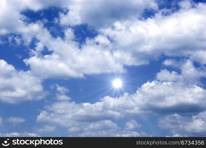 Blue sky with sun and beautiful clouds.