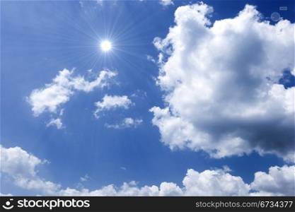 Blue sky with sun and beautiful clouds.