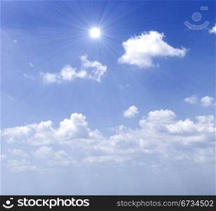 Blue sky with sun and beautiful clouds.