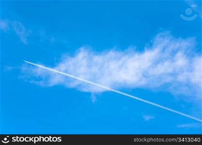 Blue sky with transparent cloud and plane trace