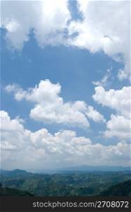 Blue sky with white cloud in sunny day, horizon with mountains