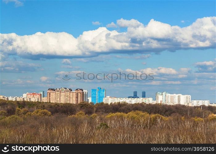 blue sky with white clouds over city and forest in sunny spring day, Moscow, Russia