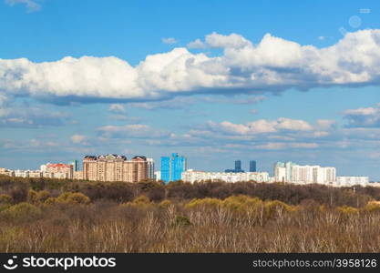 blue sky with white clouds over city and forest in sunny spring day, Moscow, Russia