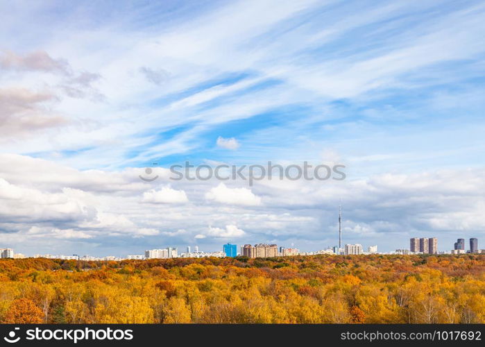 blue sky with white clouds over yellow city park on sunny autumn day