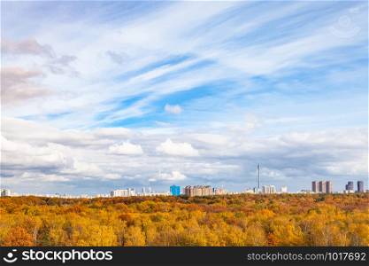 blue sky with white clouds over yellow city park on sunny autumn day