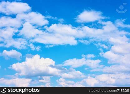 Blue sky with white cumulus clouds, may be used as background