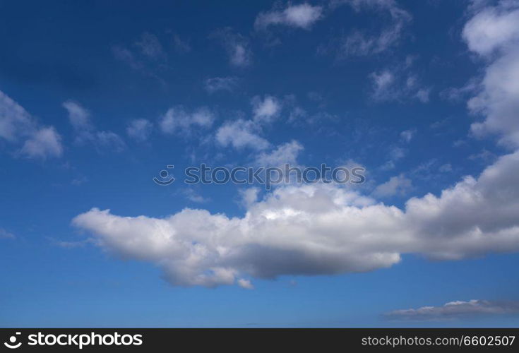 Blue sky with white summer cumulus clouds