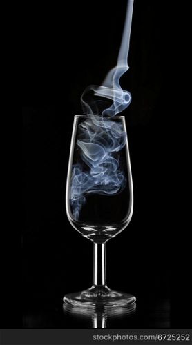 blue smoke in a glass of sherry