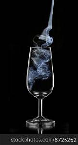 blue smoke in a glass of sherry