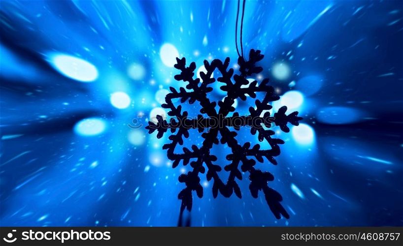 Blue snowy Christmas holiday background with tree decoration snowflake ornament and bokeh lights
