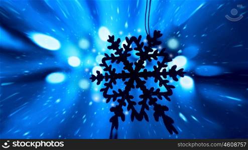 Blue snowy Christmas holiday background with tree decoration snowflake ornament and bokeh lights