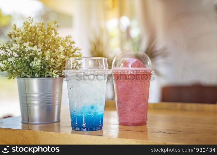 Blue soda in plastic cup put on table. beverange in plastic cup put on table