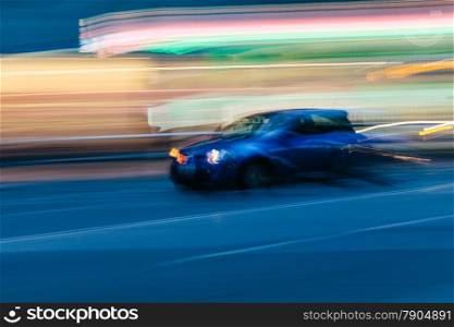 Blue Sports Car in a Blurred City Scene