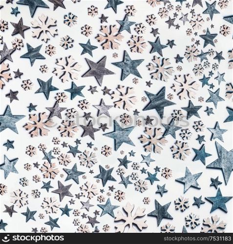 Blue stars and snowflakes pattern on white background. Top view. Creative holiday concept. Flat lay. White blue colors. Winter layout