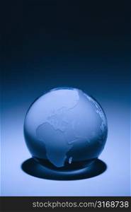 Blue still life of globe showing continents of Europe, Asia and Africa.