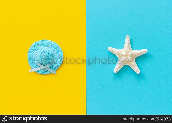 Blue straw hat on yellow paper and sea starfish on blue background Minimal style Copy space Template for lettering, text or your design Creative Top View. Concept Hello summer or vacation.. Blue straw hat on yellow paper and sea starfish on blue background Minimal style Copy space Template for lettering, text or your design Creative Top View. Concept Hello summer or vacation